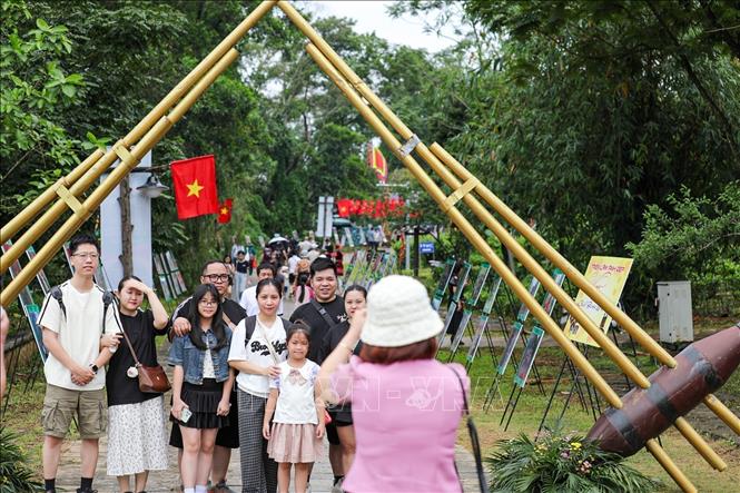 Tourists check in at the Vietnam National Village for Ethnic Culture and Tourism. VNA Photo