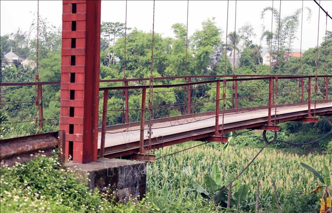 Những sợi dây cáp treo hoen gỉ, mòn vẹt, một số thanh ngăn mặt cầu bung rời xuống cấp trầm trọng. Ảnh: Tạ Toàn – TTXVN