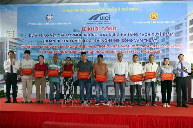 Tặng quà cho các hộ dân sớm bàn giao mặt bằng để thi công dự án. Ảnh: Tiến Lực - TTXVN