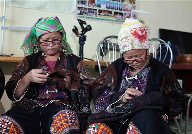 Lo Lo women skillfully embroider floral patterns on traditional attire. VNA Photo: Trần Việt