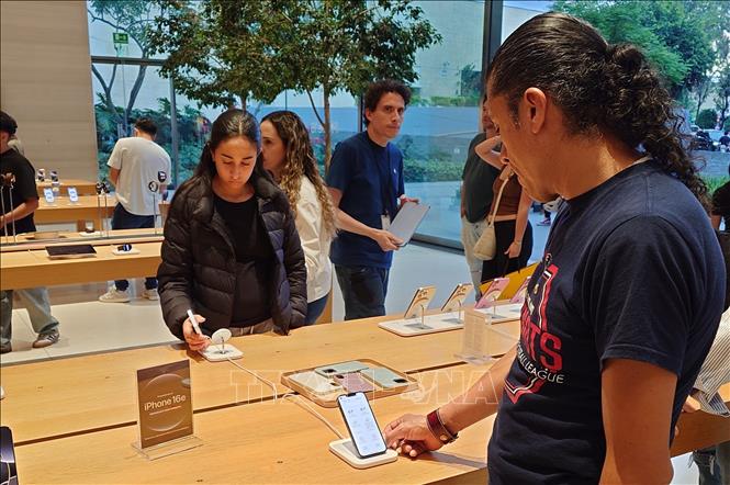 Khách hàng trải nghiệm điện thoại iPhone tại một trung tâm phân phối của Apple ở thủ đô Mexico City, Mexico. Ảnh: Phi Hùng - PV TTXVN tại Mexico.
