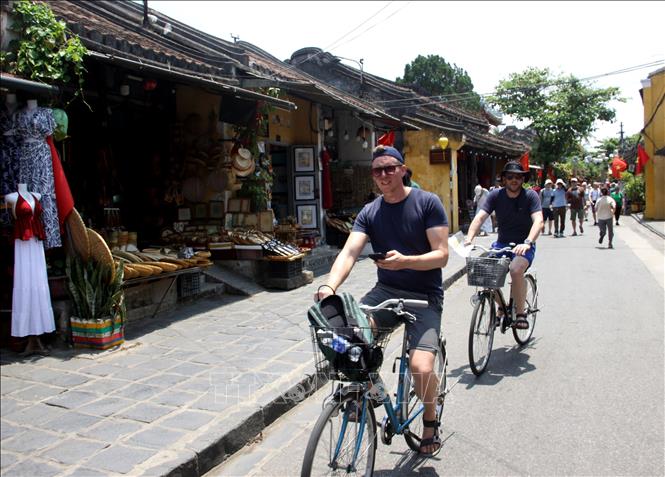 Foreign tourists experience bike tours of Hoi An. VNA Photo