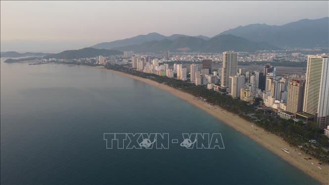 Nha Trang white-sand beach runs 7km, curving on blue sea to embrace the city. VNA Photo