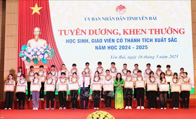 Phó Bí thư Thường trực Tỉnh ủy, Chủ tịch HĐND tỉnh Yên Bái Tạ Văn Long và Phó Chủ tịch UBND tỉnh Yên Bái Vũ Thị Hiền Hạnh trao tặng Bằng khen của Chủ tịch UBND tỉnh cho học sinh có thành tích xuất sắc. Ảnh: Đinh Thùy - TTXVN