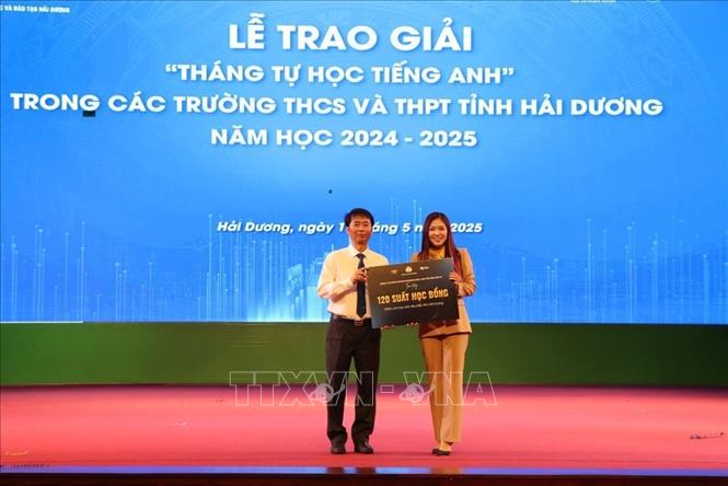 Phó Giám đốc Sở Giáo dục và Đào tạo Hải Dương Đỗ Duy Hưng nhận biển tượng trưng 120 suất học bổng do Tập đoàn Giáo dục Atlantic tài trợ tặng học sinh Hải Dương. Ảnh: Mạnh Minh – TTXVN