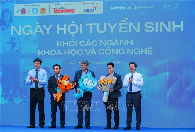 Tặng hoa các nhà khoa học, các diễn giả tham dự sự kiện. Ảnh: Hoàng Hiếu - TTXVN
