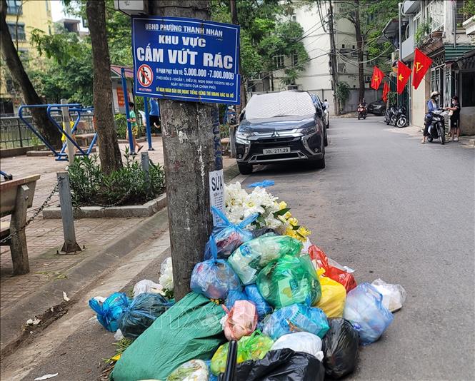 Người dân vẫn đổ rác dù có biển cấm. Ảnh: Phương Anh - TTXVN