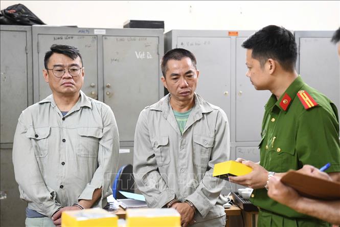 Lực lượng chức năng bắt giữ các đối tượng và thu giữ tang vật vụ án. TTXVN phát