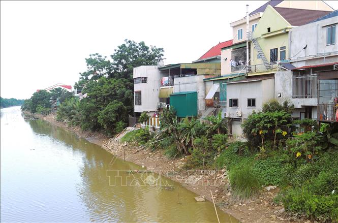 Nhiều công trình công trình ở nằm “chênh vênh” bên mép nước trên hành lang kênh Vách Bắc đối diện với nguy cơ sụt lún, sạt trượt rất cao, nhất là vào mùa mưa lũ. Ảnh: Xuân Tiến - TTXVN 