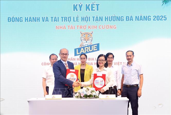 Đại diện các doanh nghiệp thực hiện nghi thức cam kết đồng hành, hỗ trợ chương trình Lễ hội Tận hưởng Đà Nẵng 2025. Ảnh: Trần Lê Lâm - TTXVN 