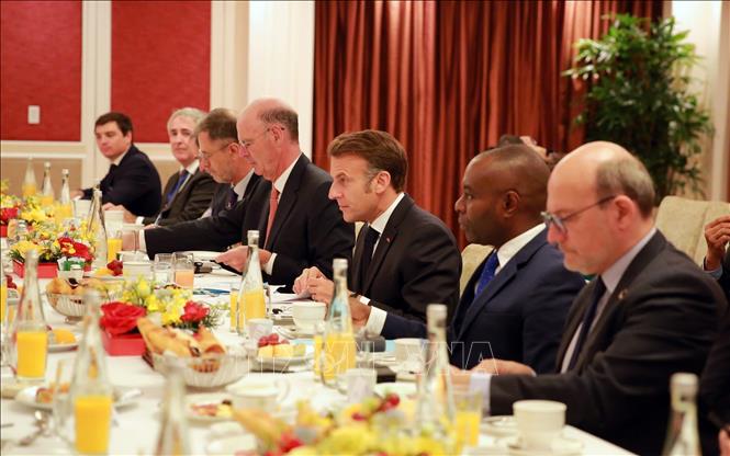 French President Emmanuel Macron at the working breakfast. VNA Photo/Photo by courtesy