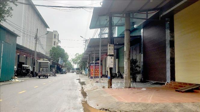 Hàng loạt cửa hàng dọc chợ Thổ Tang cửa đóng then cài. Ảnh: Hoàng Hùng - TTXVN