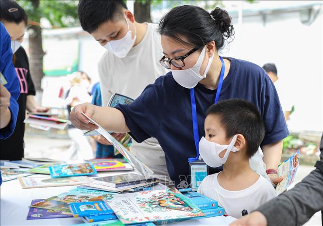 Gian hàng sách truyện thiếu nhi được người nhà và bệnh nhân nhi quan tâm lui tới. Ảnh: Lê Đông – TTXVN 