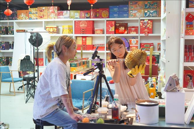 Cửa hàng sầu riêng tại chợ đầu mối Tân Phát Địa livestream bán hàng. Ảnh: Quang Hưng -P/v TTXVN tại Bắc Kinh