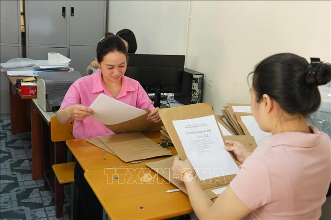 Kiểm tra hồ sơ thí sinh tại Hội đồng thi trường THPT Hà Huy Tập, thành phố Vinh (Nghệ An). Ảnh: Bích Huệ - TTXVN
