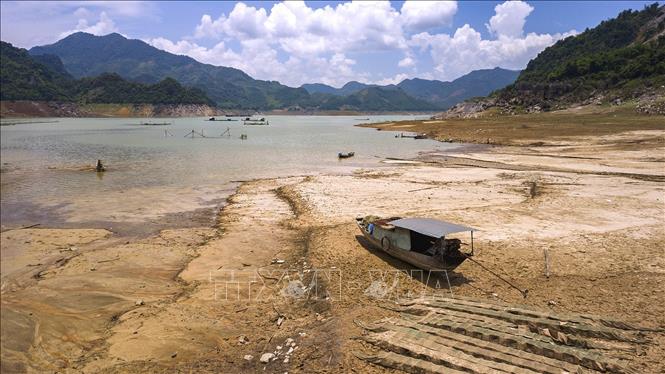 Một con thuyền bị mắc cạn khi nước xuống quá nhanh khiến người dân không kịp kéo thuyền ra vùng nước sâu thuộc địa phận xã Hiền Lương, Đà Bắc. Ảnh: Trọng Đạt-TTXVN