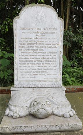 Stele inscribed with the name of the Hung Kings Ancestral Temple stands beside the shrine. VNA Photo: Tạ Toàn