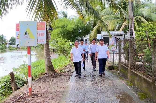 Lãnh đạo Chi cục Thủy lợi (Sở Nông nghiệp và Môi trường thành phố Cần Thơ) và chính quyền địa phương khảo sát các điểm sạt lở bờ sông Ô Môn đoạn qua địa bàn xã Tân Thạnh và xã Thới Thạnh ngày 13/6. Ảnh: TTXVN phát