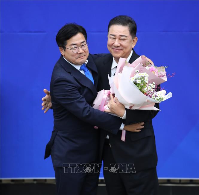 Nghị sĩ Kim Byung-kee nhận hoa chúc mừng từ người tiền nhiệm sau khi được bầu làm Chủ tịch mới của đảng Dân chủ (DP) cầm quyền ở Hàn Quốc, ngày 13/6/2025. Ảnh: YONHAP/TTXVN