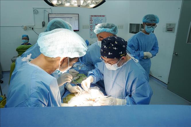 Các bác sĩ Bệnh viện Thống Nhất Thành phố Hồ Chí Minh thực hiện ghép thận cho bệnh nhân từ nguồn thận hiến của người chết não. Ảnh: TTXVN phát                               