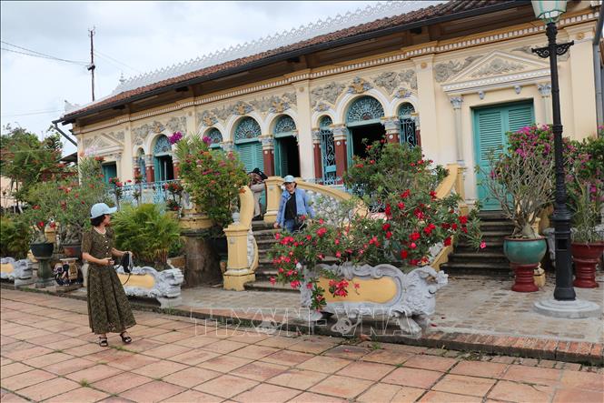 The house has five main sections across its 22-meter width and three layers of depth, including a front, middle, and back area extending 16 meters deep. It features brick walls, a wooden framework, and a three-layer tiled roof, which keeps the house bright and airy. VNA Photo: Hồng Nhung