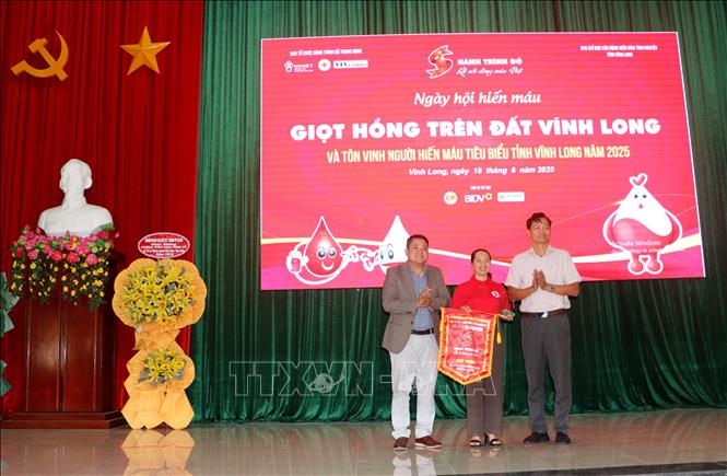 Ban Tổ chức Hành trình Đỏ Trung ương đã trao tặng biểu trưng lưu niệm cho Ban Chỉ đạo Vận động hiến máu tình nguyện tỉnh Vĩnh Long. Ảnh: Lê Thúy Hằng – TTXVN