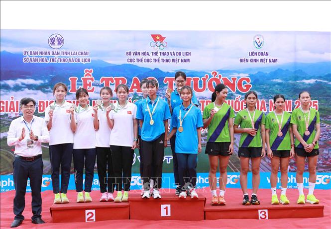 Phó giám đốc Sở Văn hóa Thể thao và Du lịch, Trần Quang Kháng trao huy chương cho các vận động viên nội dung tiếp sức 4x400m. Ảnh: Quý Trung – TTXVN
