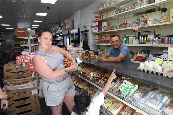 British customers are delighted to enjoy the taste of Vietnamese lychee. VNA Photo: Phong Hà 