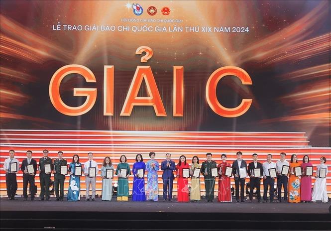 Tổng giám đốc TTXVN Vũ Việt Trang và Thứ trưởng Thường trực Bộ Văn hóa, Thể thao và Du lịch Lê Hải Bình trao giải C cho các tác giả, nhóm tác giả đoạt giải. Ảnh: Minh Quyết - TTXVN