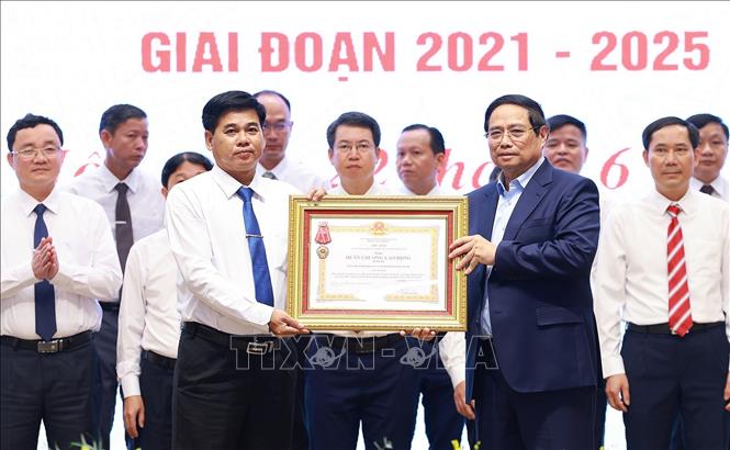 Thủ tướng Phạm Minh Chính trao Huân chương Lao động hạng Ba cho Đảng bộ, chính quyền và nhân dân huyện có thành tích xuất sắc trong Phong trào thi đua “Cả nước chung tay xây dựng nông thôn mới”. Ảnh: Dương Giang-TTXVN