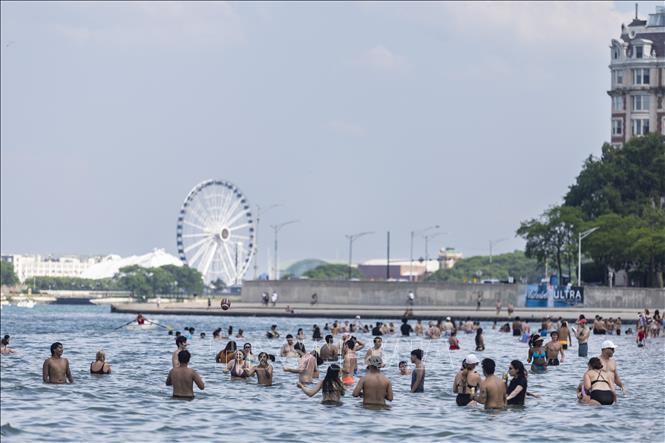 Người dân tắm hồ để giải nhiệt trong ngày nắng nóng tại Michigan, Chicago, Mỹ. Ảnh: THX/TTXVN