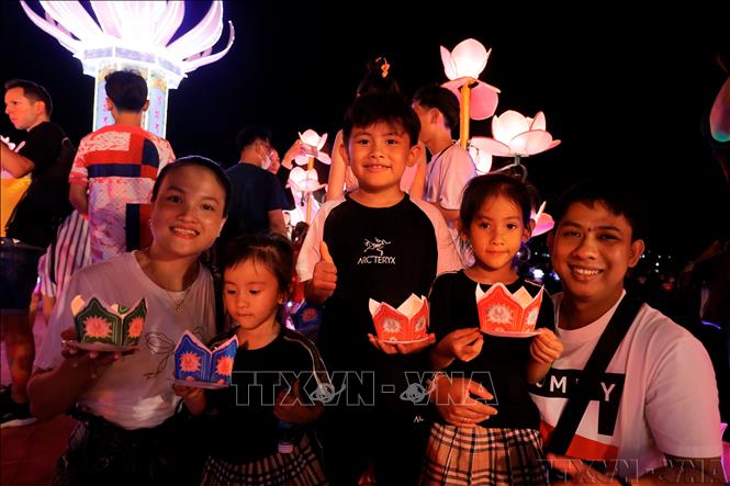 Cả gia đình cùng tham gia thả hoa đăng tại Tuần lễ Festival nghệ thuật Quốc tế Huế 2024. Ảnh: Minh Quyết – TTXVN