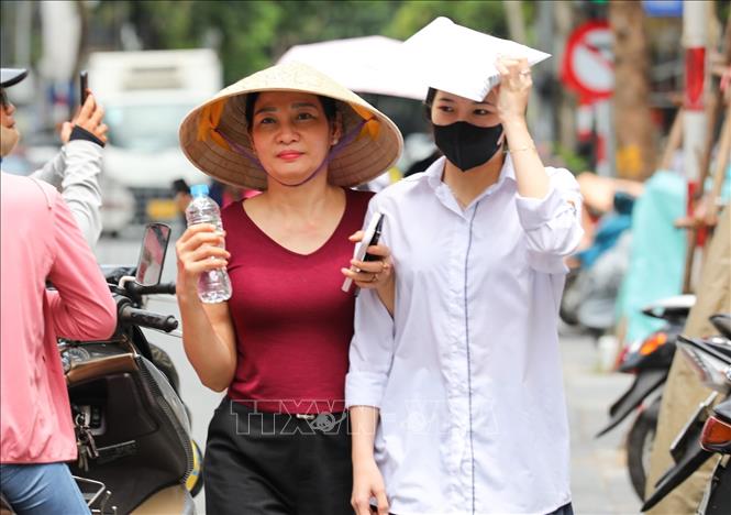 Phụ huynh đồng hành cùng con đến điểm thi trường THCS Ngô Sĩ Liên (quận Hoàn Kiếm, Hà Nội). Ảnh: Khánh Hoà - TTXVN
