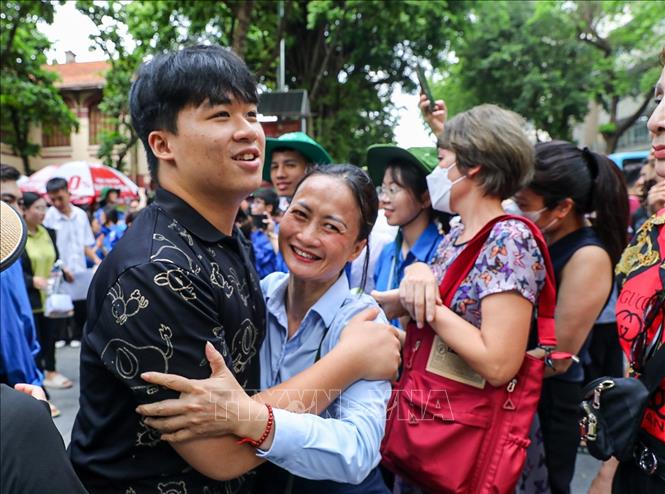 Phụ huynh chia sẻ cảm xúc với thí sinh sau khi hoàn thành bài thi môn thi Toán Kỳ thi tốt nghiệp THPT năm 2025 tại điểm thi trường Trần Phú (quận Hoàn Kiếm). Ảnh: Khánh Hoà - TTXVN