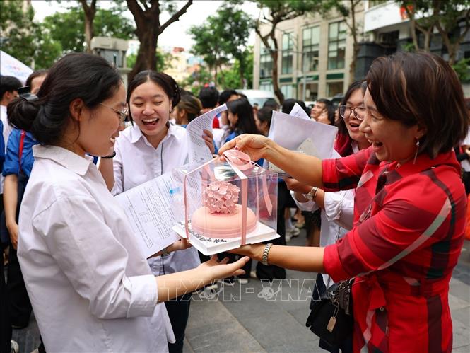 Thí sinh được tặng bánh kem và hát mừng sinh nhật ngay khi ra khỏi điểm thi trường THCS Trưng Vương, quận Hoàn Kiếm. Ảnh: Thanh Tùng - TTXVN 