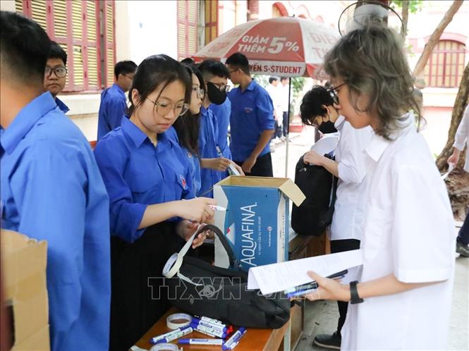 Thanh niên tình nguyện hỗ trợ thí sinh tại điểm trường THPT Trần Phú (quận Hoàn Kiếm, Hà Nội). Ảnh: Khánh Hoà - TTXVN
