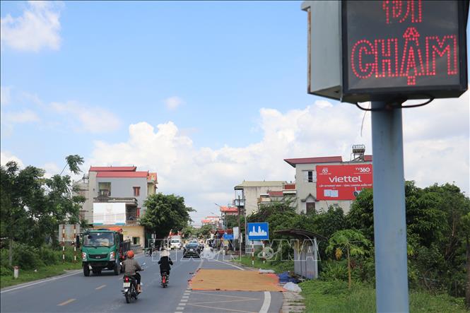 Người dân lấn chiếm hành lang an toàn giao thông để phơi thóc trên tuyến đường ĐT454, đoạn qua địa phận huyện Vũ Thư (Thái Bình). Ảnh: Vũ Quang - TTXVN