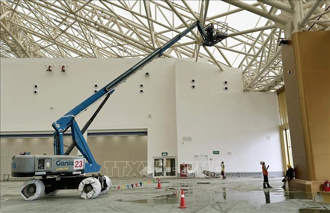 Nhà thầu kiểm tra hệ thống vòm mái thép bên trong khu vực nhà triển lãm Kim Quy. Ảnh: Quốc Khánh - TTXVN