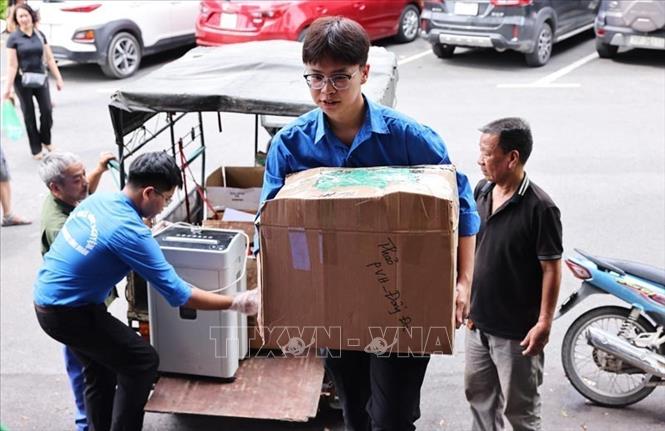 Đoàn viên thanh niên dọn dẹp và vận chuyển, xắp xếp đồ dùng tại trụ sở Phường Đống Đa (mới) để 1/7 chính thức đi vào hoạt động của chính quyền địa phương hai cấp trên địa bàn thành phố Hà Nội. Ảnh: Minh Đức – TTXVN

