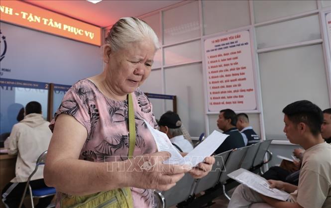 Cụ bà được giải quyết xong thủ tục hành chính tại trụ sở UBND phường Hoàng Mai, số 6 Bùi Huy Bích. Ảnh: Trần Việt - TTXVN