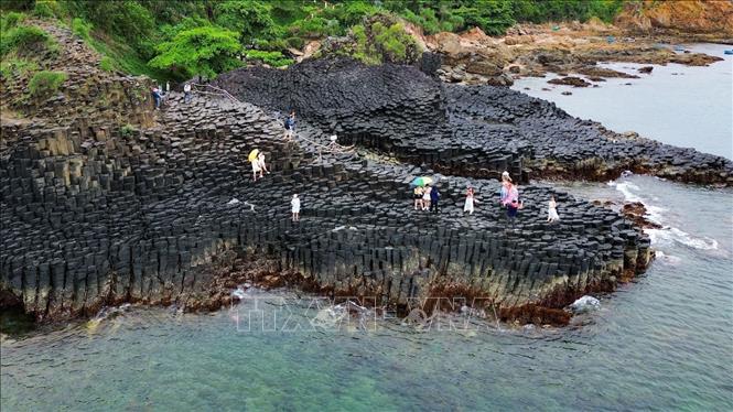 The jet black color of basalt contrasts with the clear blue color of the ocean, creating an impressive natural scenery. VNA Photo