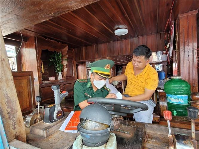 Biên phòng cảng Bến Lội - Bình Châu kiểm tra giấy tờ tàu cá của ngư dân xã Bình Châu, TP. Hồ Chí Minh trước khi ra khơi đánh bắt. Ảnh: Hoàng Nhị - TTXVN.