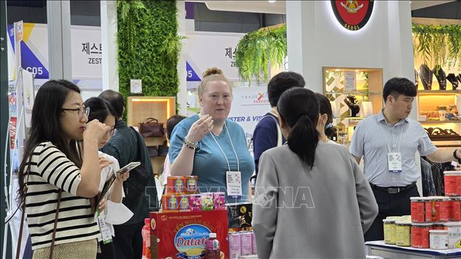 Khách nước ngoài tham quan và thử đồ uống tại một gian hàng chất lượng cao của Việt Nam. Ảnh: Đức Thắng - P/v TTXVN tại Hàn Quốc