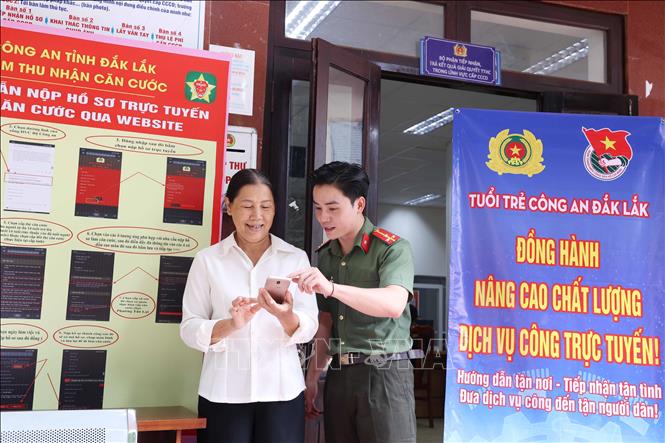 Tình nguyện viên Đội hình tình nguyện Công an tỉnh Đắk Lắk hỗ trợ người dân thực hiện thủ tục hành chính và thao tác cơ bản trên thiết bị điện thoại. Ảnh: Hoài Thu – TTXVN