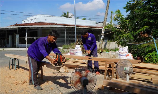 Thành viên Tổ cất nhà từ thiện Tân Thạnh, tỉnh Đồng Tháp, góp công cất nhà cho gia đình có hoàn cảnh khó khăn. Ảnh: Nhựt An - TTXVN
