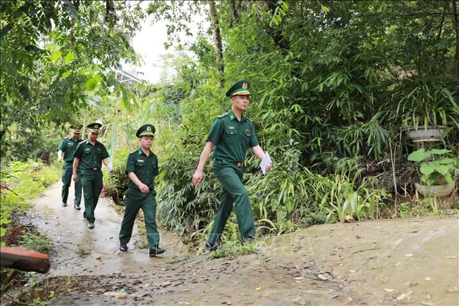 Cán bộ Đồn Biên phòng xuống bản, vào từng hộ dân để tuyên truyền về hòm thư diện tử ẩn danh tố giác tội phạm. Ảnh: Quý Trung - TTXVN