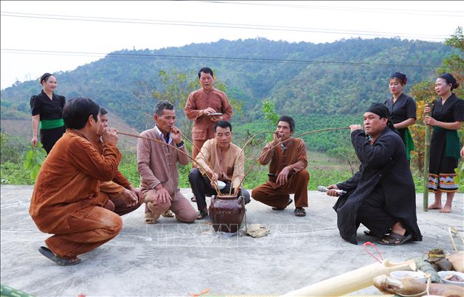 Sau lễ làm vía, buộc chỉ vào cổ tay và lễ đặt tên, thầy mo và các già làng, trưởng bản, người uy tín cùng uống rượu cần, thụ lộc. Ảnh: Xuân Tiến - TTXVN 