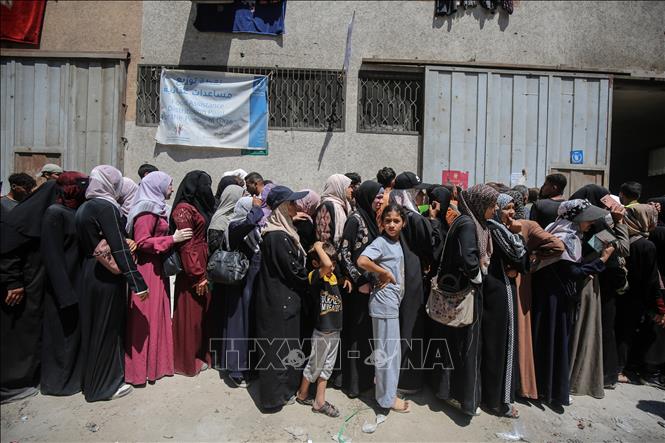 Người dân Palestine chờ được phát thực phẩm cứu trợ tại Gaza. Ảnh: THX/TTXVN
