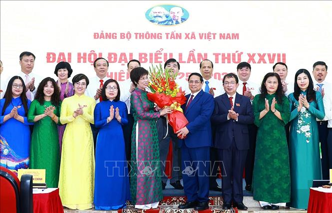 Đồng chí Phạm Minh Chính, Uỷ viên Bộ Chính trị, Bí thư Đảng uỷ Chính phủ, Thủ tướng Chính phủ tặng hoa chúc mừng Ban Chấp hành Đảng bộ Thông tấn xã Việt Nam lần thứ 27, nhiệm kỳ 2025 - 2030. Ảnh: Dương Giang - TTXVN
