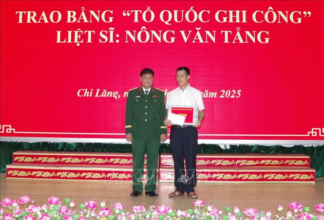 Lãnh đạo Ban Chỉ huy phòng thủ khu vực 3-Nhân Lý, tỉnh Lạng Sơn tặng quà cho thân nhân liệt sĩ Nông Văn Tẳng. Ảnh: Anh Tuấn – TTXVN